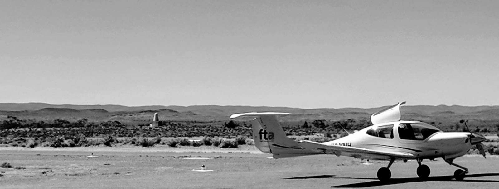 A light aircraft on a remote outback airstrip in Australia — fly-in fly-out to the rigs
